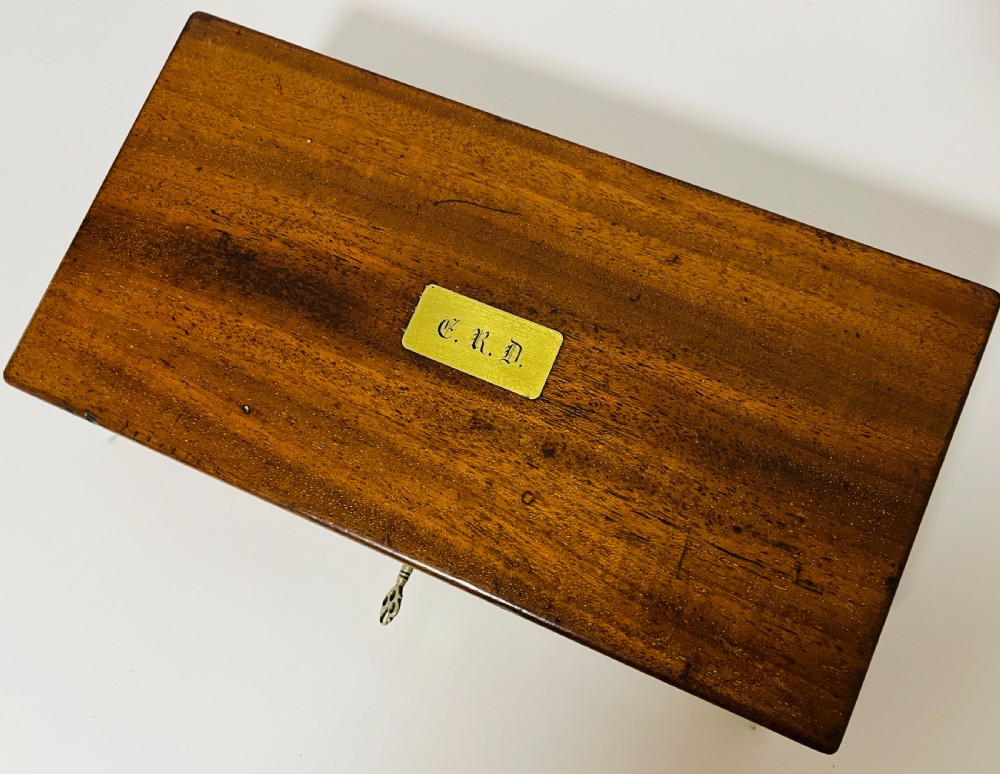 An open Victorian mahogany vanity box featuring a dark leather-lined interior with fitted glass jars topped with silver-coloured lids. View IV