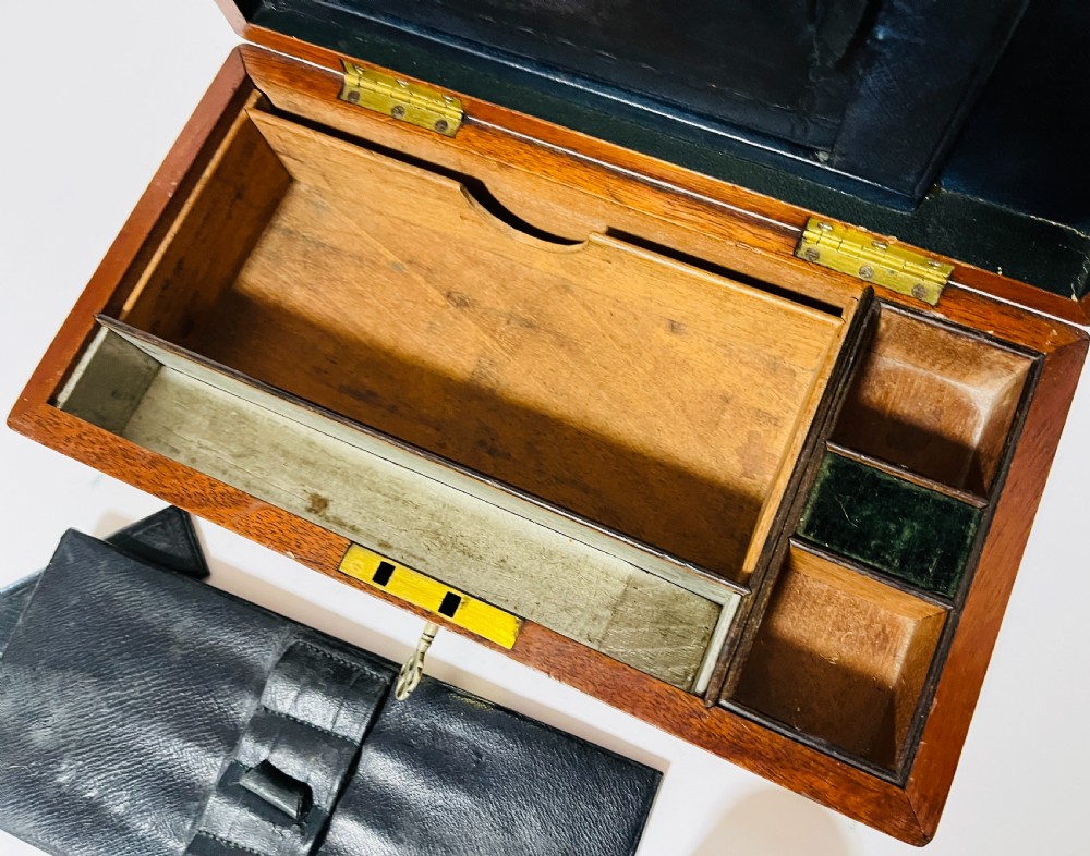 An open Victorian mahogany vanity box featuring a dark leather-lined interior with fitted glass jars topped with silver-coloured lids. View V