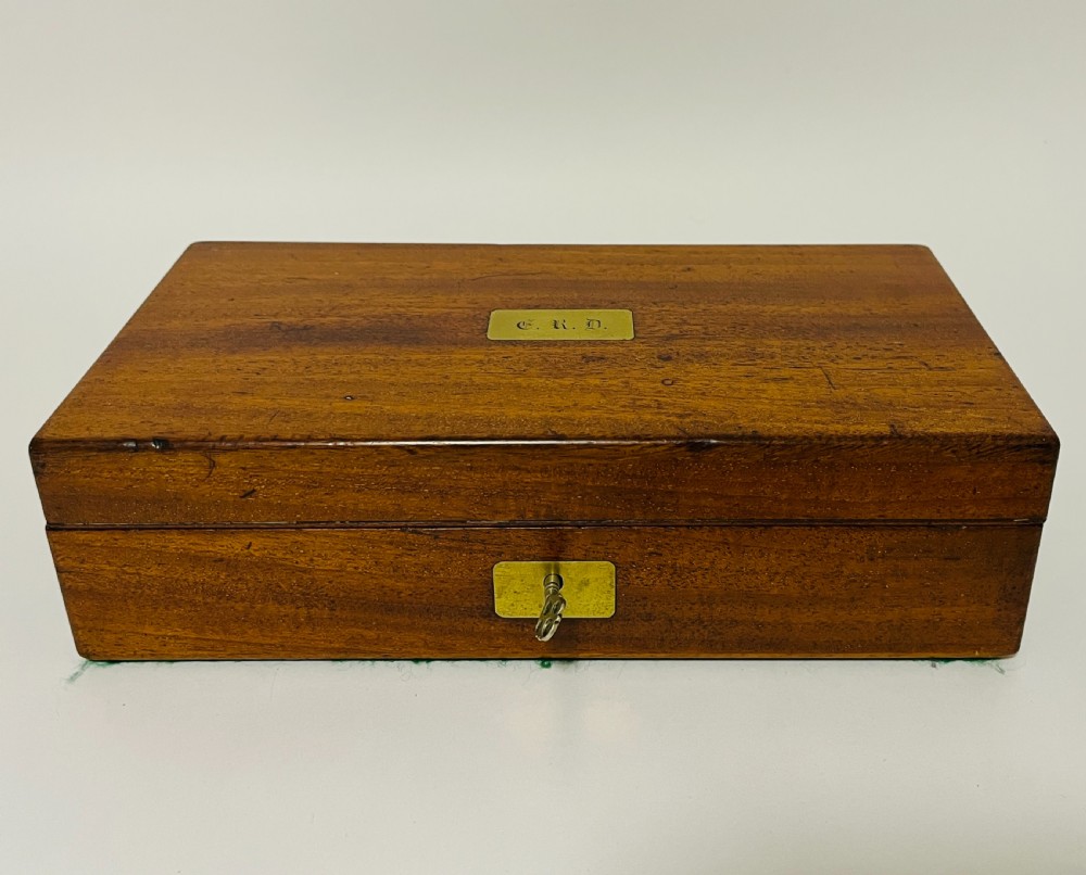 An open Victorian mahogany vanity box featuring a dark leather-lined interior with fitted glass jars topped with silver-coloured lids. View VIII