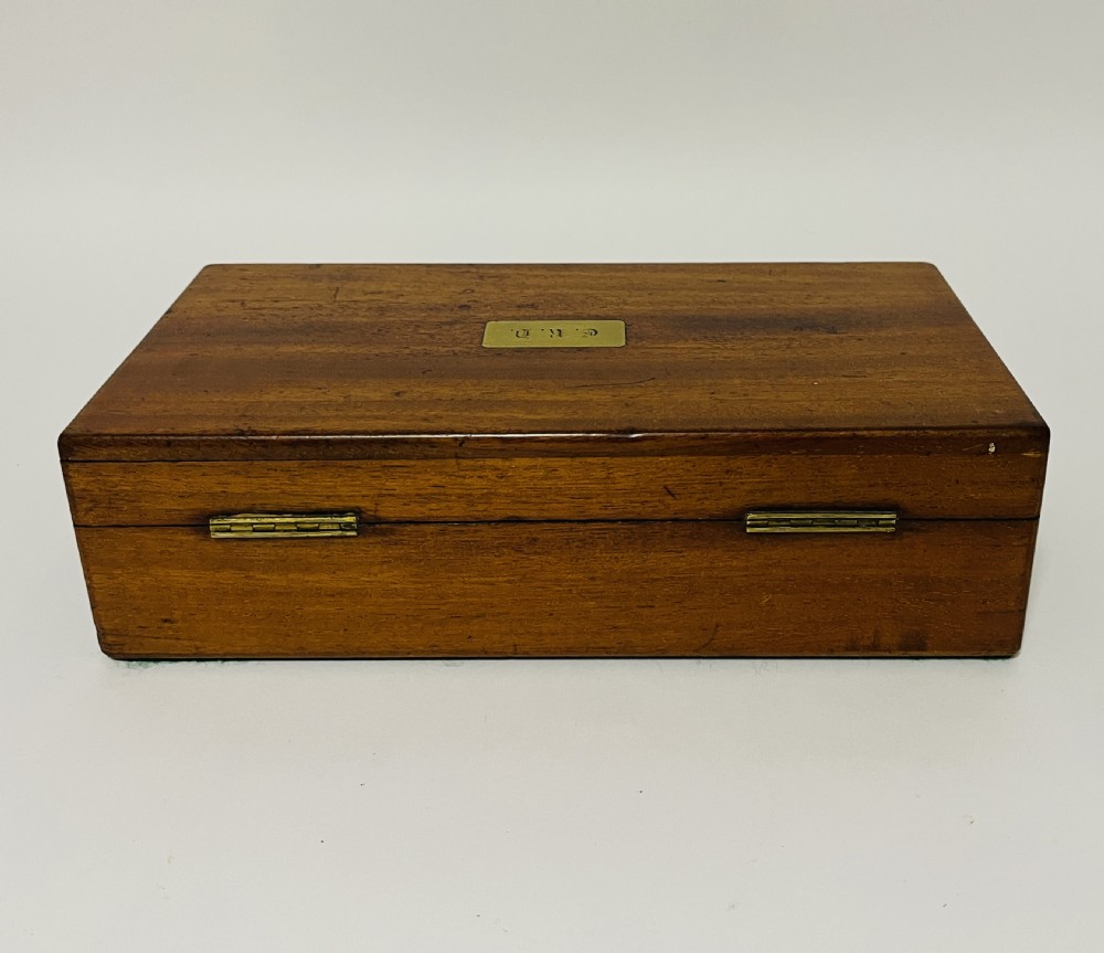 An open Victorian mahogany vanity box featuring a dark leather-lined interior with fitted glass jars topped with silver-coloured lids. View XII