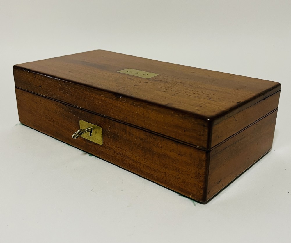 An open Victorian mahogany vanity box featuring a dark leather-lined interior with fitted glass jars topped with silver-coloured lids. View XIII
