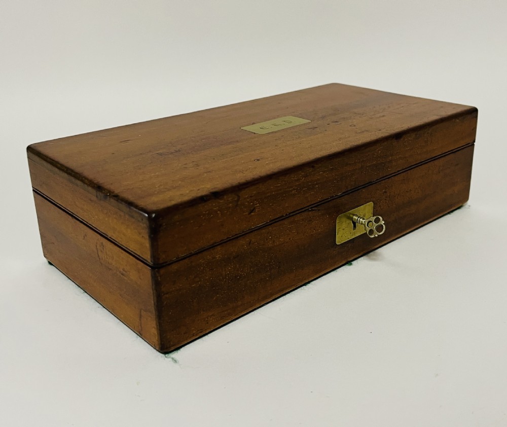 An open Victorian mahogany vanity box featuring a dark leather-lined interior with fitted glass jars topped with silver-coloured lids. View XVI