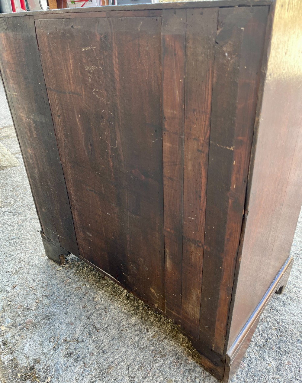 An antique dark oak Georgian bureau featuring a slant front, ornate brass escutcheons, lopers, and bracket feet. View XVI