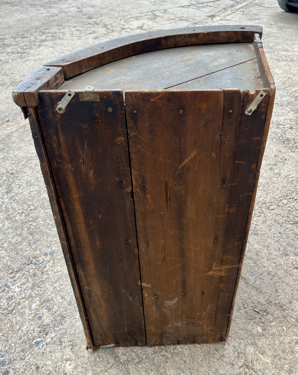 A Georgian bow-fronted mahogany hanging corner cupboard with twin doors and decorative brass escutcheons. View XIII