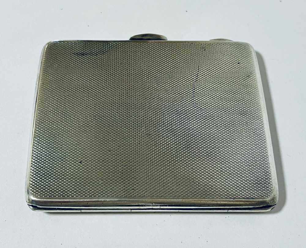 An Art Deco rectangular silver cigarette case featuring a pale yellow translucent enamel panel over a sunburst guilloche pattern. View IV