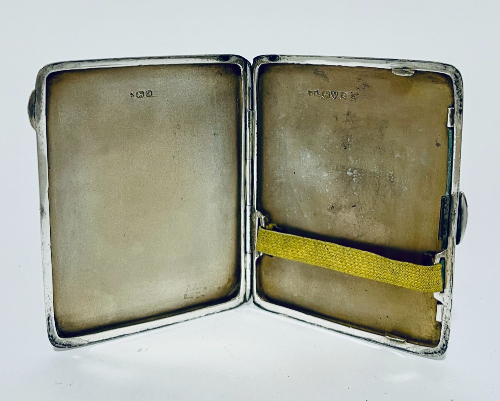 An Art Deco rectangular silver cigarette case featuring a pale yellow translucent enamel panel over a sunburst guilloche pattern. View VI