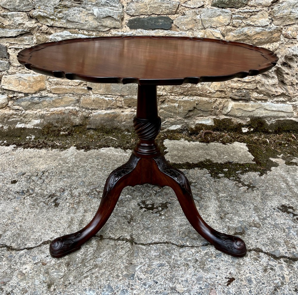 A Georgian mahogany tilt-top side table featuring a scalloped pie-crust edge, turned central column, and carved tripod cabriole legs. View II