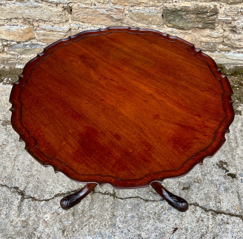 A Georgian mahogany tilt-top side table featuring a scalloped pie-crust edge, turned central column, and carved tripod cabriole legs. View III