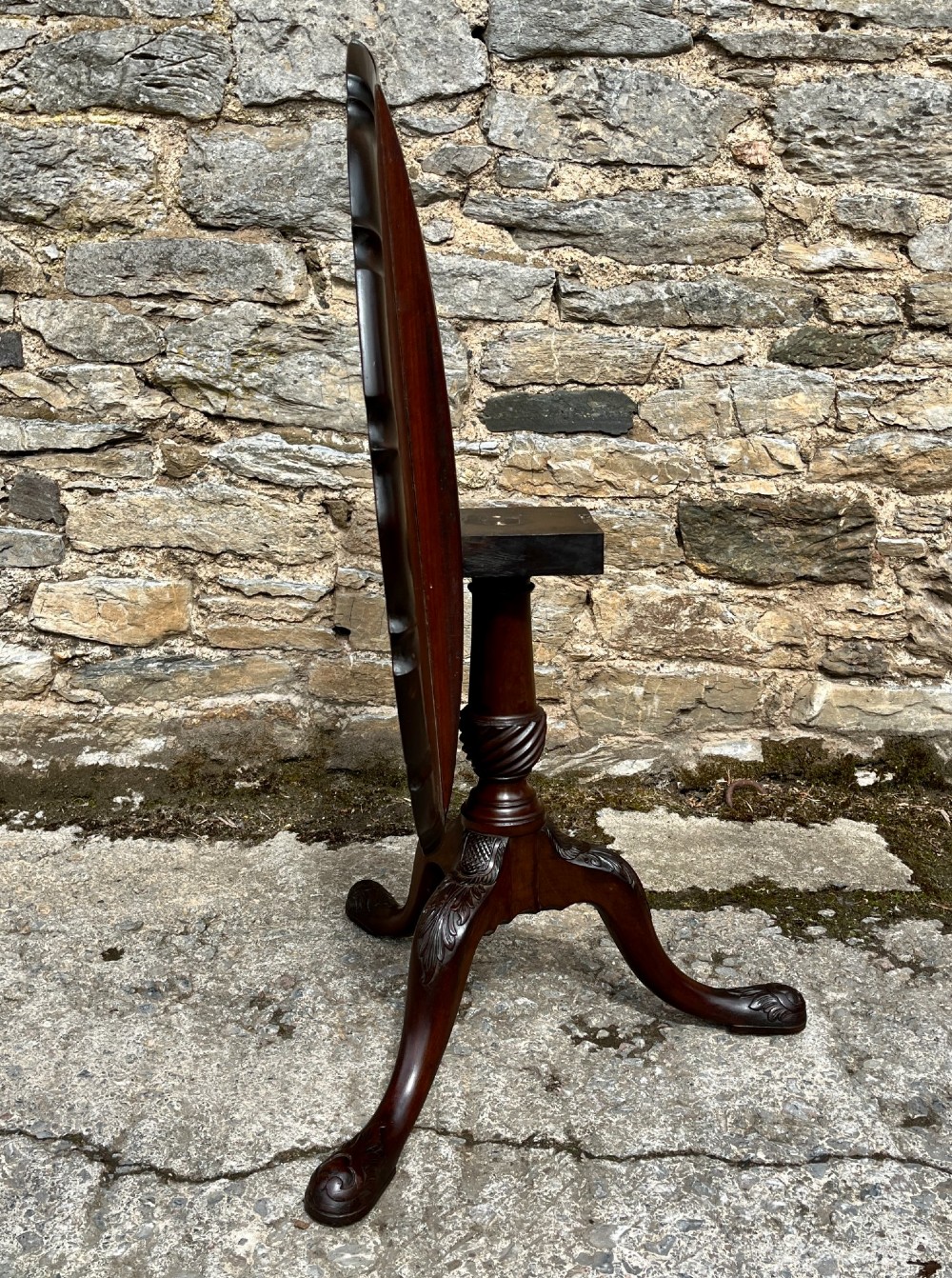 A Georgian mahogany tilt-top side table featuring a scalloped pie-crust edge, turned central column, and carved tripod cabriole legs. View XII