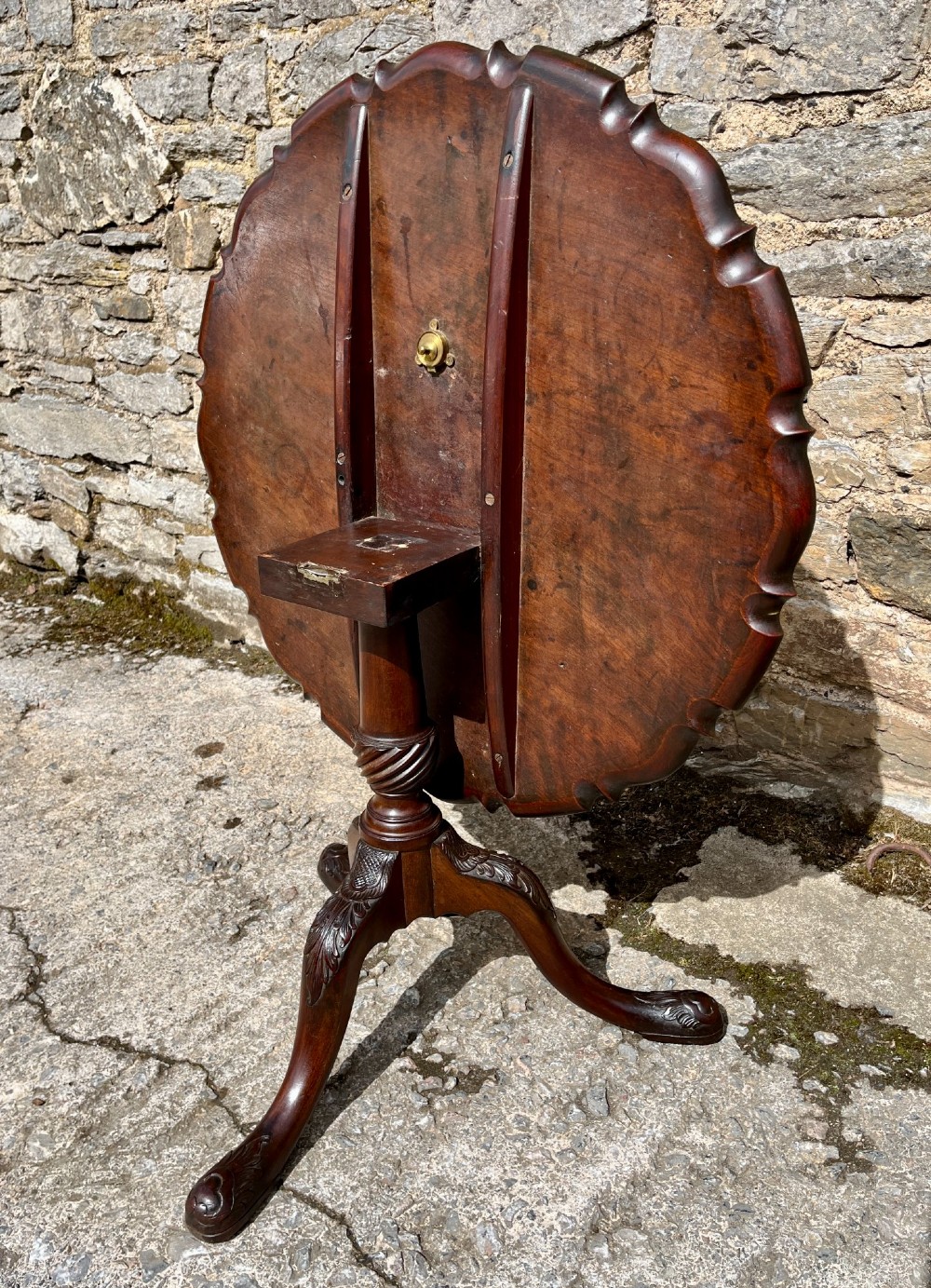 A Georgian mahogany tilt-top side table featuring a scalloped pie-crust edge, turned central column, and carved tripod cabriole legs. View XIII