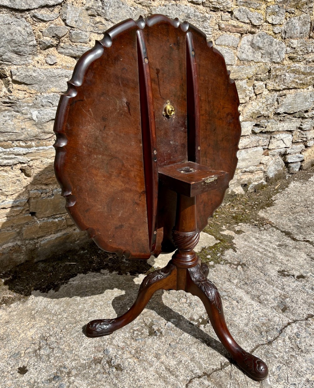 A Georgian mahogany tilt-top side table featuring a scalloped pie-crust edge, turned central column, and carved tripod cabriole legs. View XIV