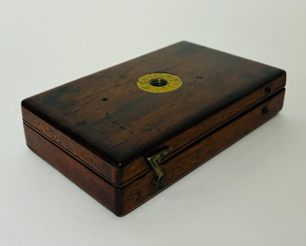 A 19th-century brass botanical field microscope mounted upright on a polished mahogany wooden storage box base. View XIII