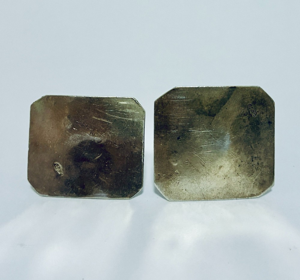 A pair of miniature silver figures depicting figures with a bucket and a walking stick on square patterned bases. View V