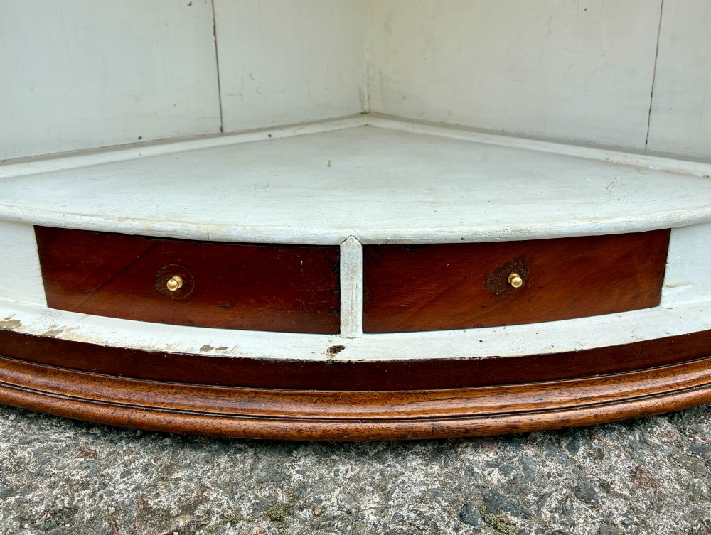 A Georgian bow-front mahogany corner cupboard featuring detailed marquetry inlays, decorative brass hinges, and central keyhole escutcheons. View XIV
