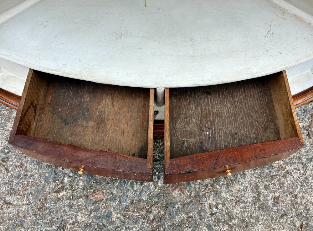 A Georgian bow-front mahogany corner cupboard featuring detailed marquetry inlays, decorative brass hinges, and central keyhole escutcheons. View XV