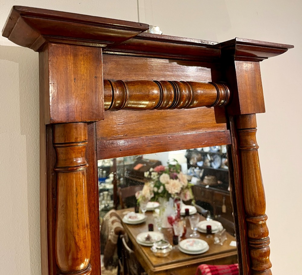 A vertical antique mahogany pier mirror featuring turned column pilasters on either side and a protruding moulded top cornice. View IV