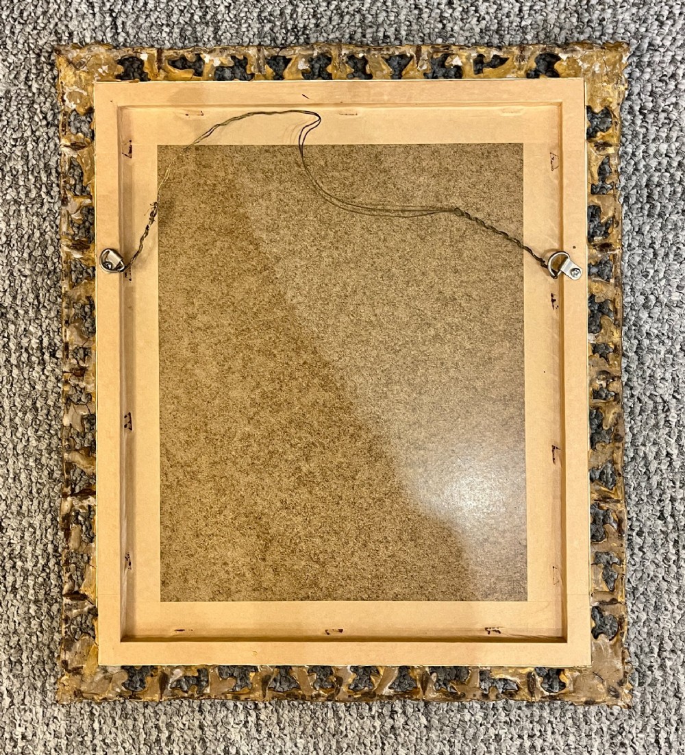 A rectangular wall mirror featuring an ornate pierced giltwood frame decorated with carved acanthus leaf scrollwork and bead moulding. View VI