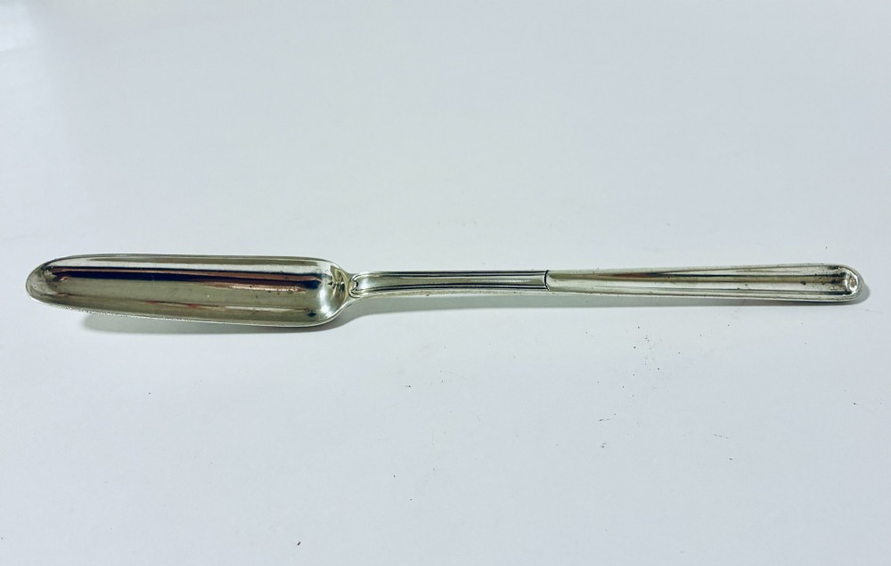 An elongated Georgian silver marrow scoop featuring a deep concave channel end tapering along a linear stem. View II