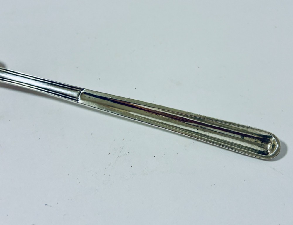 An elongated Georgian silver marrow scoop featuring a deep concave channel end tapering along a linear stem. View III