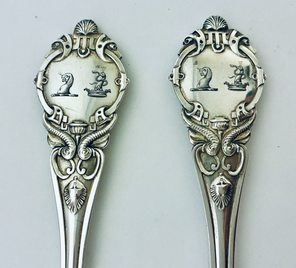 An antique Victorian silver christening spoon and fork with intricate foliate engraving, arranged inside a velvet-lined dark leather presentation case. View VIII
