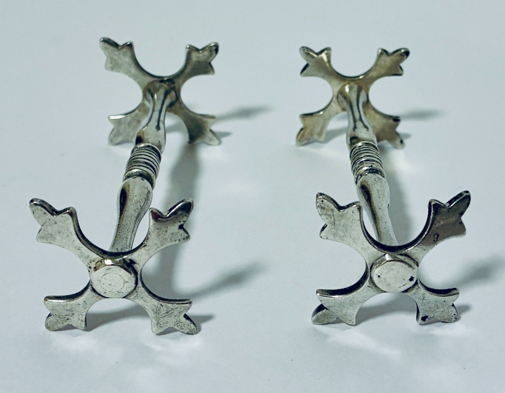 A pair of antique sterling silver knife rests with ribbed central bars and star-shaped pierced ends. View III