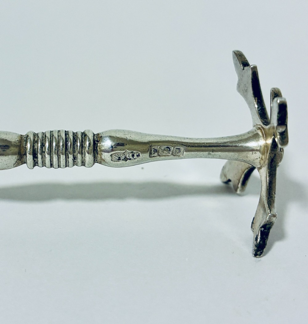 A pair of antique sterling silver knife rests with ribbed central bars and star-shaped pierced ends. View VI