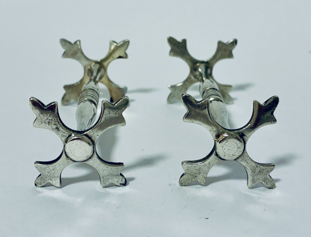A pair of antique sterling silver knife rests with ribbed central bars and star-shaped pierced ends. View VII