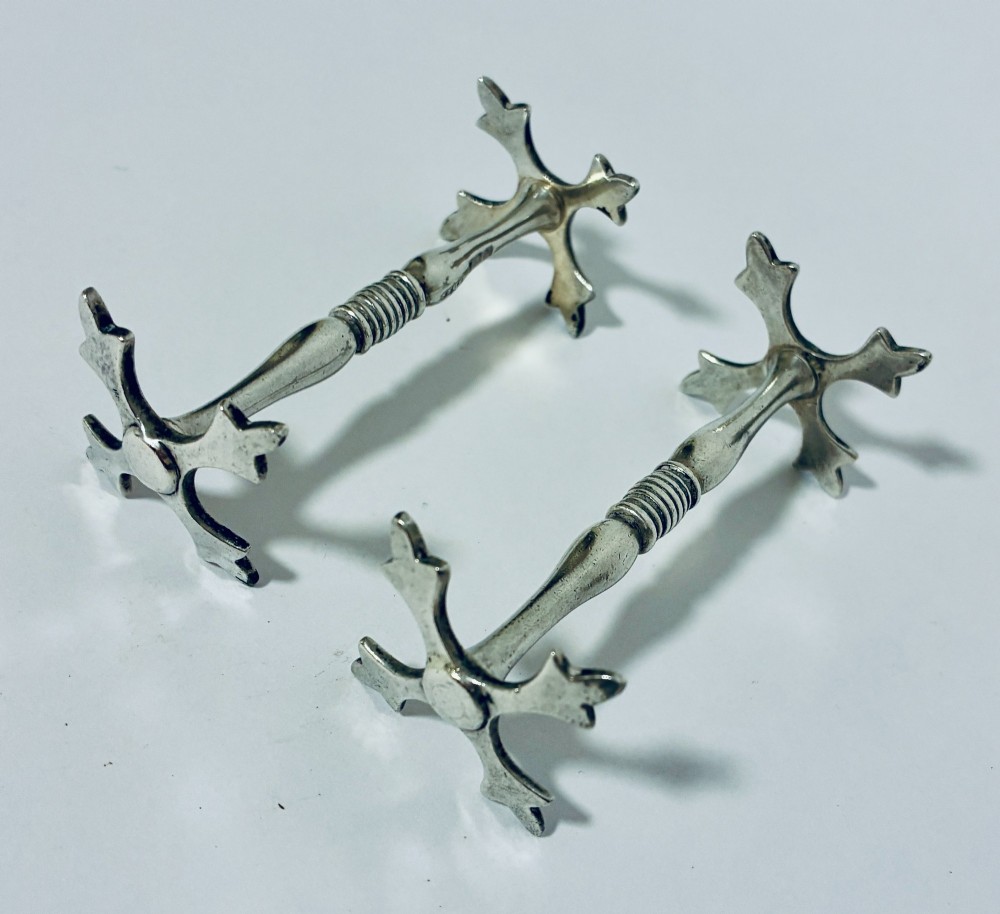 A pair of antique sterling silver knife rests with ribbed central bars and star-shaped pierced ends. View VIII