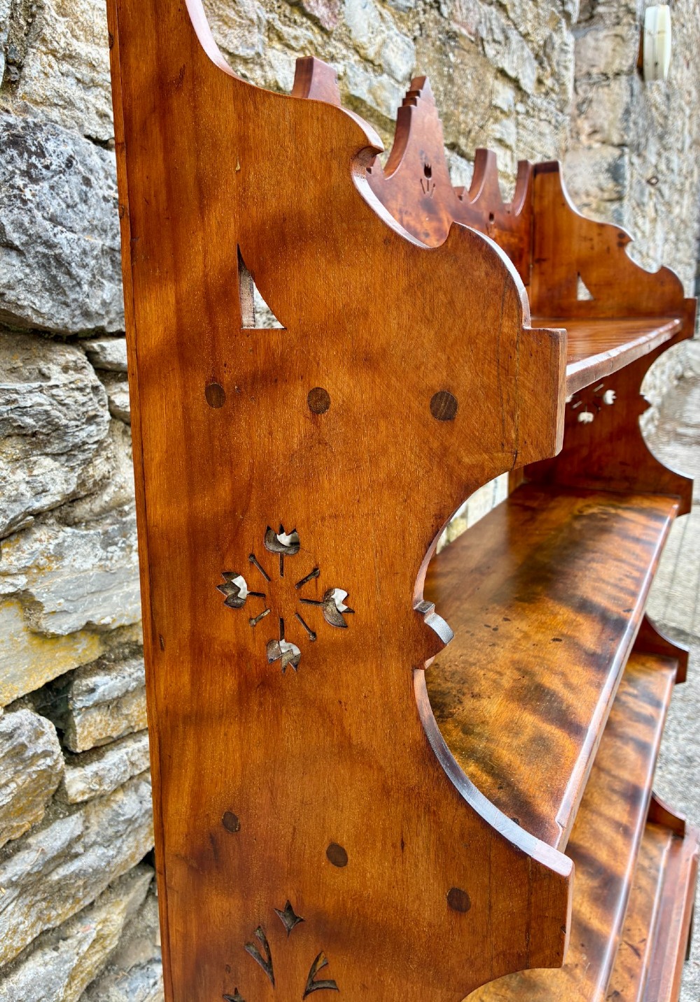 An Arts and Crafts satinwood open bookcase featuring four tiered shelves with a scalloped top gallery, shaped sides, and decorative pierced cut-outs. View IX