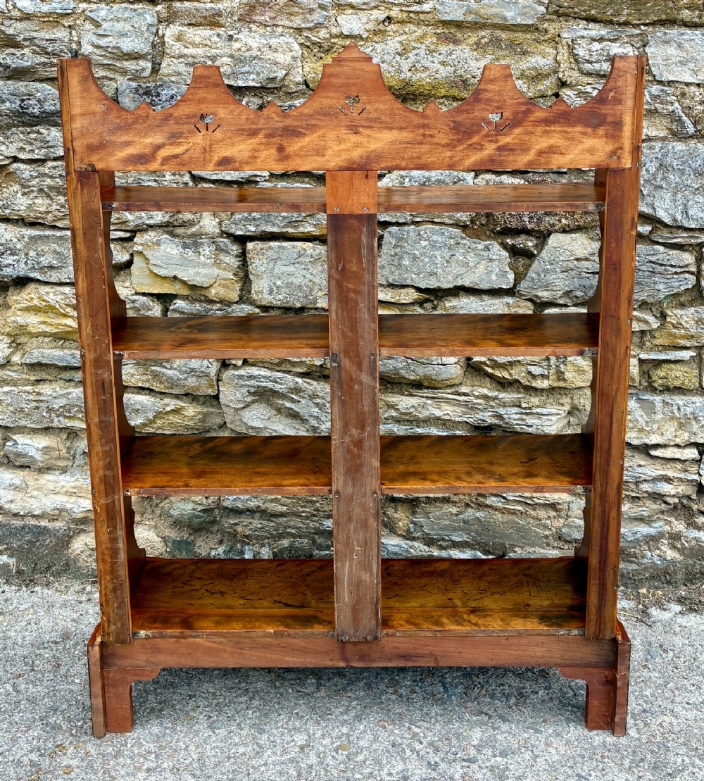 An Arts and Crafts satinwood open bookcase featuring four tiered shelves with a scalloped top gallery, shaped sides, and decorative pierced cut-outs. View XIII