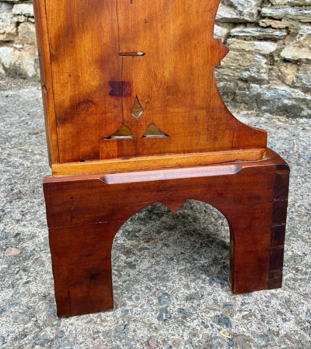 An Arts and Crafts satinwood open bookcase featuring four tiered shelves with a scalloped top gallery, shaped sides, and decorative pierced cut-outs. View XIV