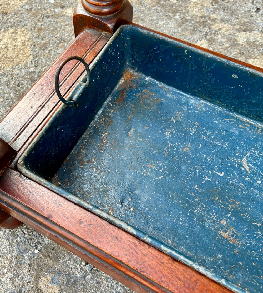 A Victorian mahogany umbrella stand with four divided top sections, turned support legs with ball finials, and a removable blue painted metal drip tray. View IX