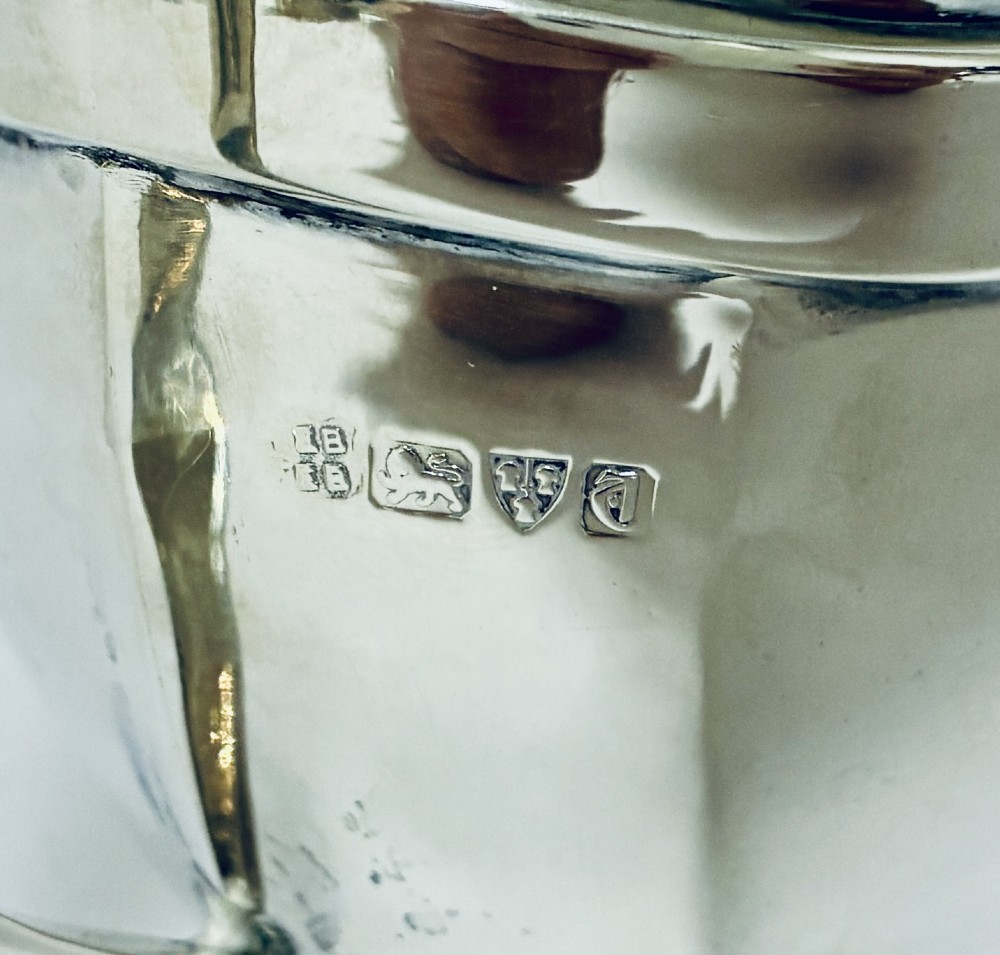 An antique polished silver milk jug featuring a faceted lower body, a shaped pouring spout with reeded rim, and an angular handle. View VI
