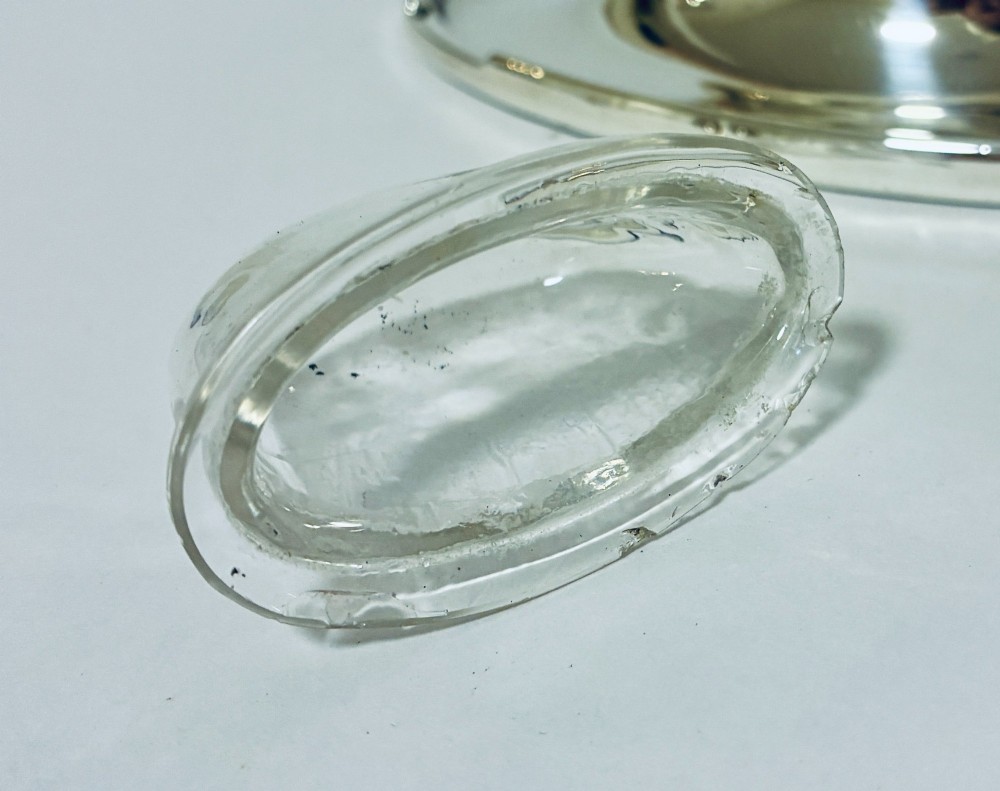 A solid silver capstan-shaped inkwell with a broad flared circular base and a hinged domed lid. View XII
