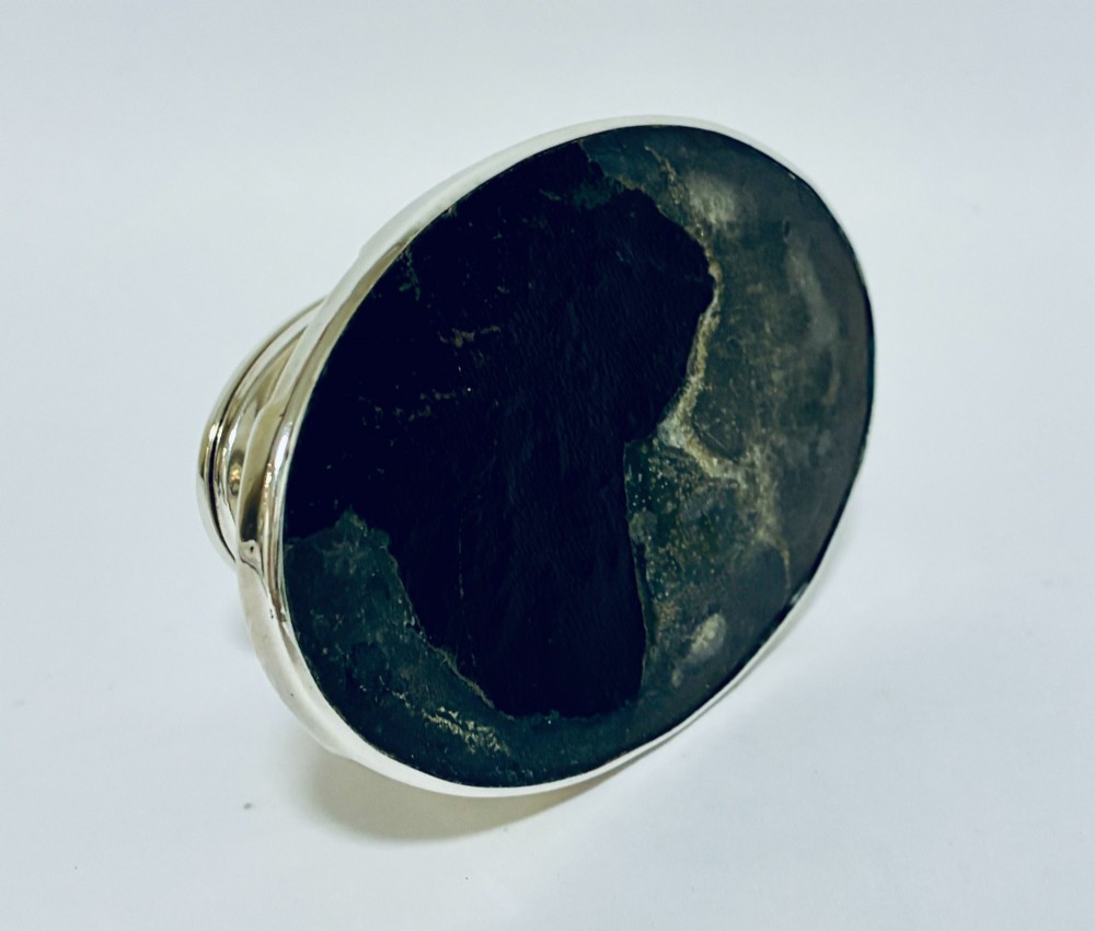 A solid silver capstan-shaped inkwell with a broad flared circular base and a hinged domed lid. View XIII