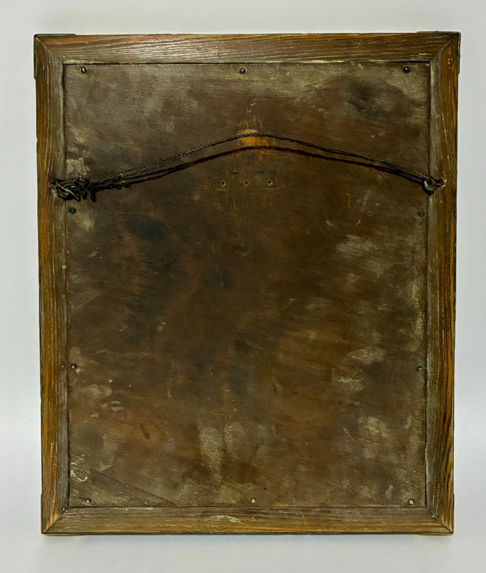 A rectangular wall mirror featuring a sheet copper frame reinforced with riveted brass corner plates. View VII