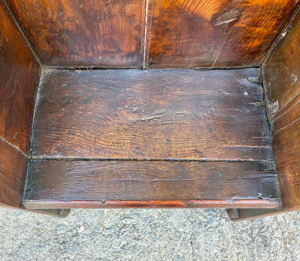 A dark oak primitive lambing chair featuring high winged sides, a tall two-panel back, a solid timber seat, and an enclosed box base. View II