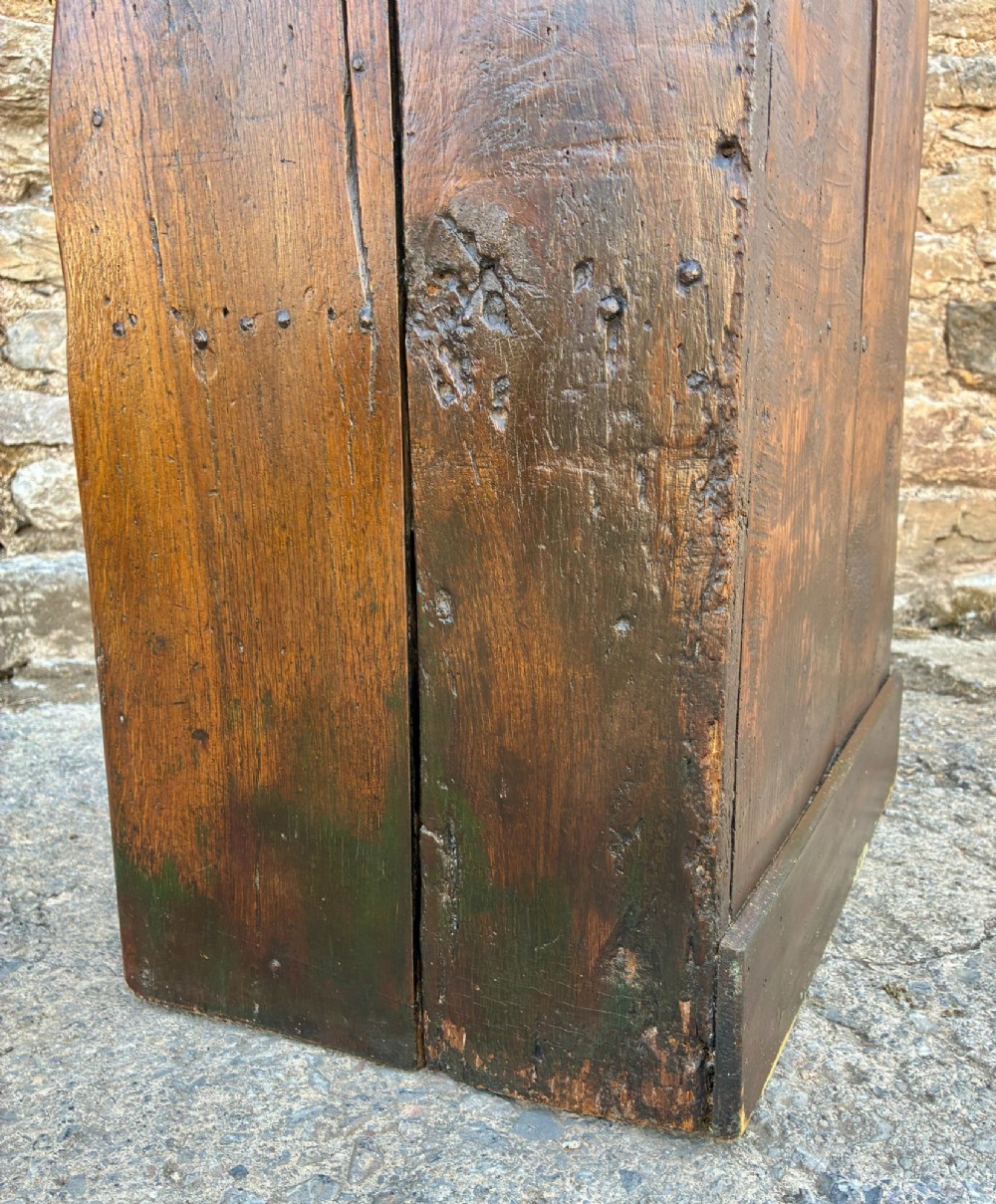 A dark oak primitive lambing chair featuring high winged sides, a tall two-panel back, a solid timber seat, and an enclosed box base. View VI