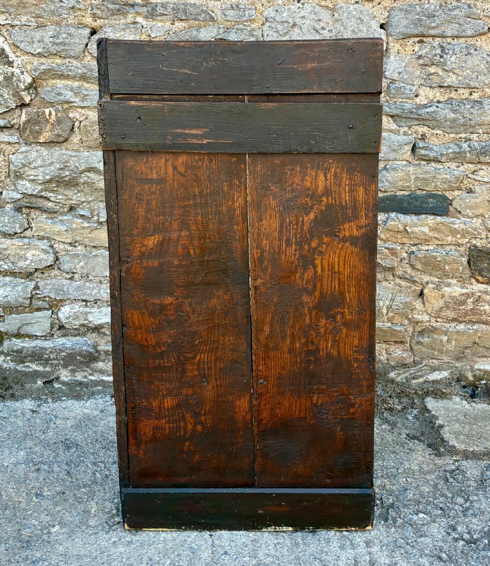 A dark oak primitive lambing chair featuring high winged sides, a tall two-panel back, a solid timber seat, and an enclosed box base. View VII