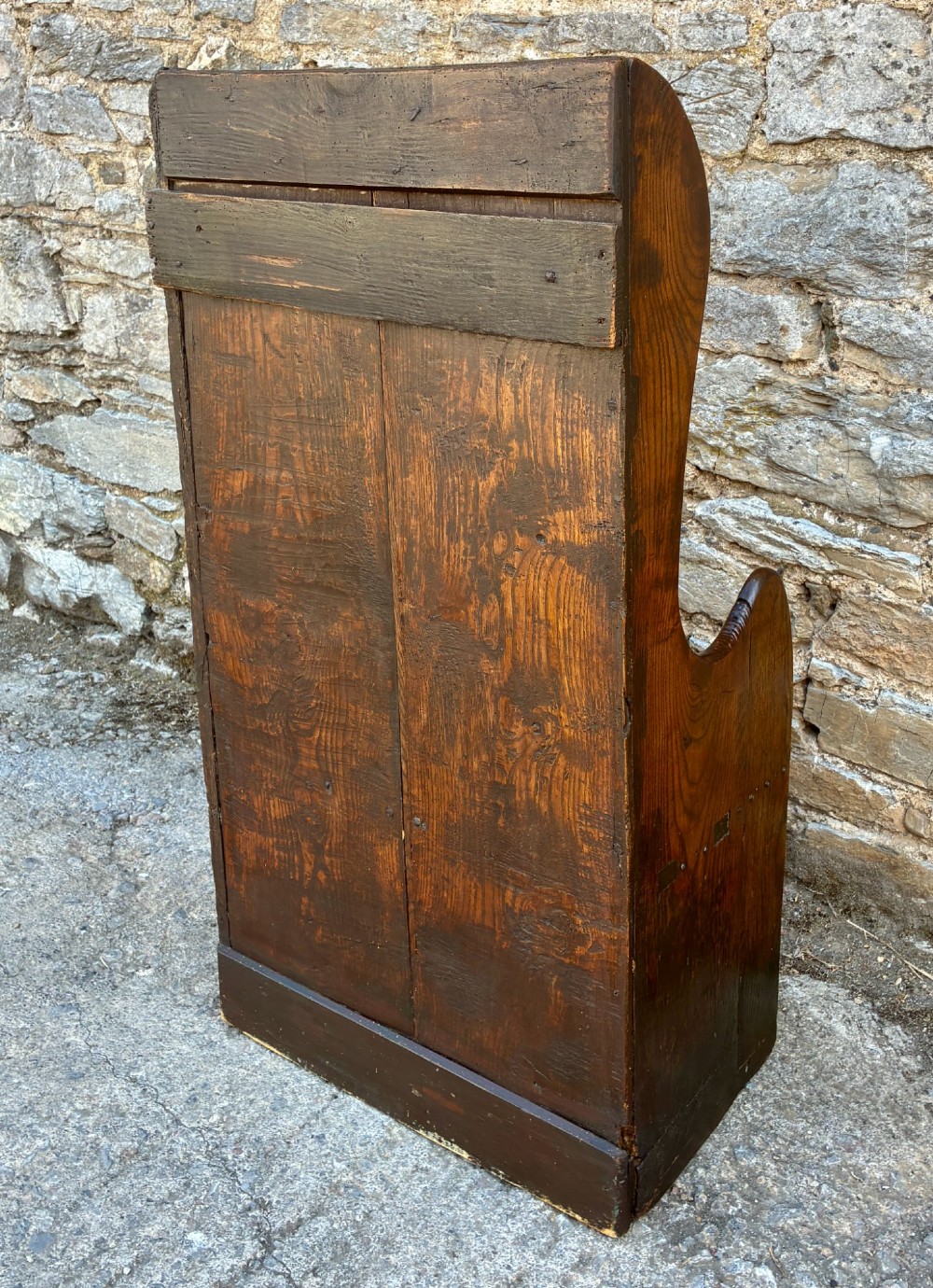 A dark oak primitive lambing chair featuring high winged sides, a tall two-panel back, a solid timber seat, and an enclosed box base. View VIII
