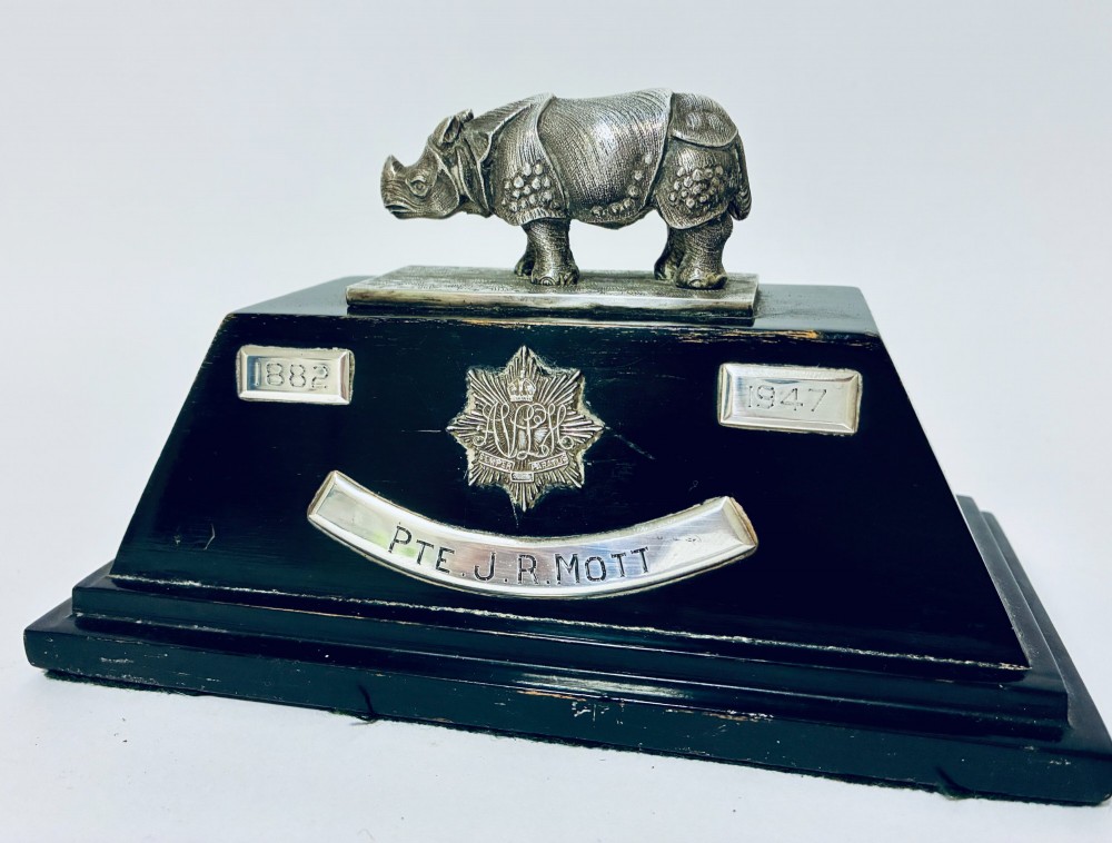 An antique silver presentation trophy featuring a detailed Indian rhinoceros figurine mounted atop a stepped ebonised wooden plinth with silver plaques. View III