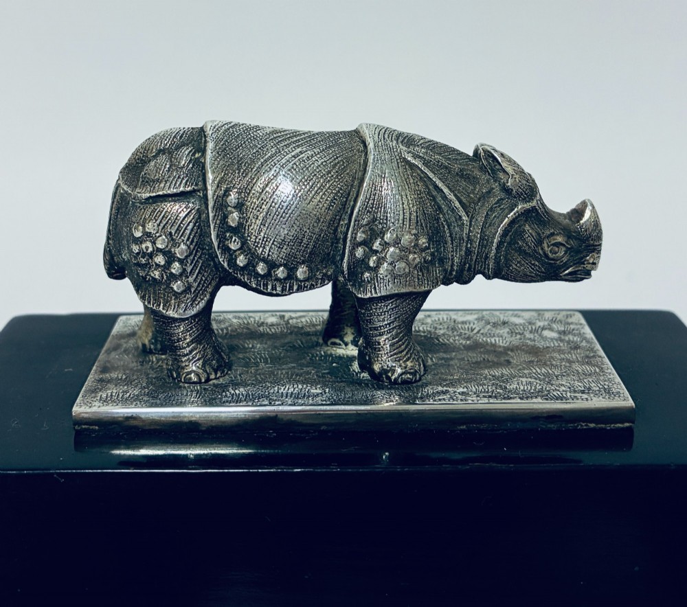 An antique silver presentation trophy featuring a detailed Indian rhinoceros figurine mounted atop a stepped ebonised wooden plinth with silver plaques. View VII