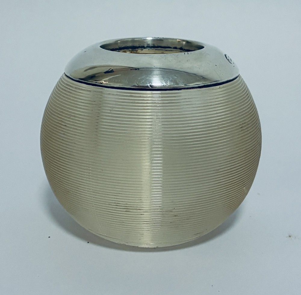 A spherical clear ribbed glass match striker featuring a polished hallmarked silver rim at the top opening. View V