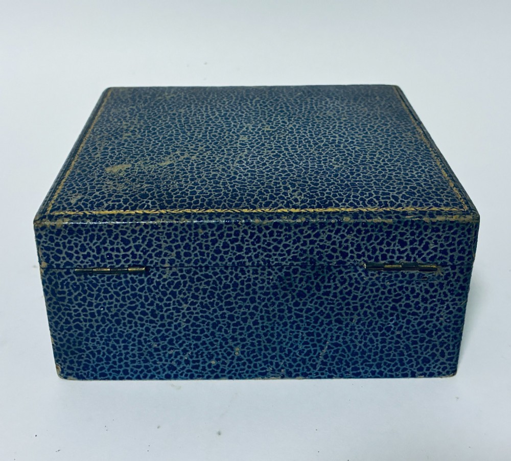 An open blue fitted presentation case displaying two silver-mounted brushes with light-coloured natural bristles against a grey velvet interior. View XIII