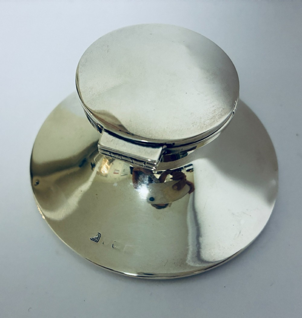 A polished silver capstan inkwell featuring a broad circular base, a tapered central waist, and a hinged flat lid. View IV