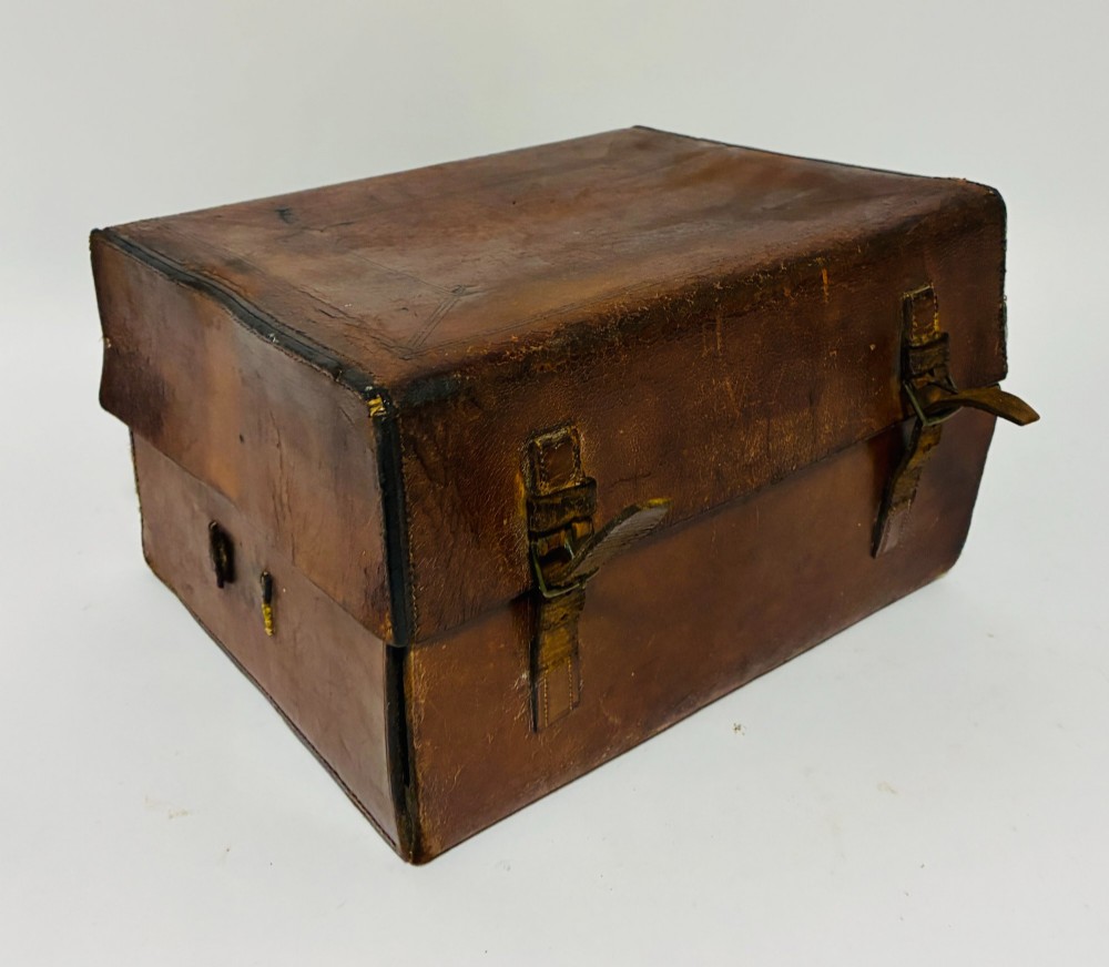 An open Victorian dark brown leather dressing case with a blue velvet-lined lid, brass lock, and compartmentalised interior sitting inside an outer leather travel box. View XV