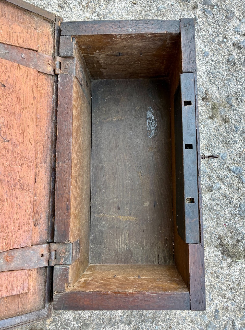 An 18th-century dark oak strong box featuring nail-head studs forming the date 1754 on the lid and three keyholes along the front fascia. View IV