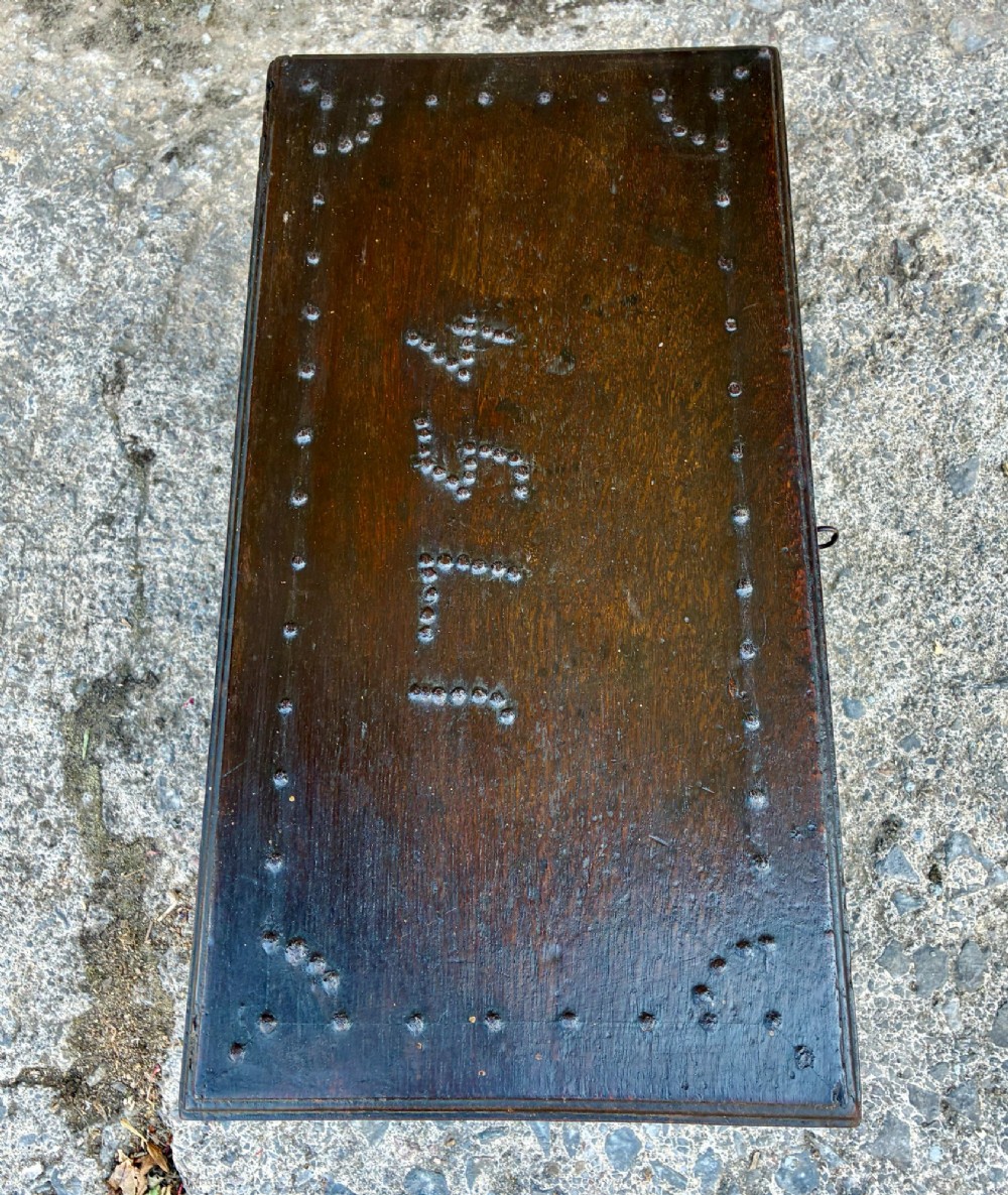 An 18th-century dark oak strong box featuring nail-head studs forming the date 1754 on the lid and three keyholes along the front fascia. View XIV