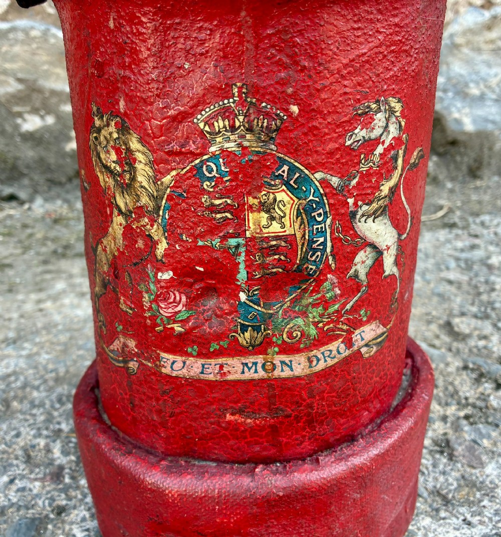 A cylindrical red leather military cordite carrier featuring a hand-painted Royal Coat of Arms and an attached leather handle. View VII