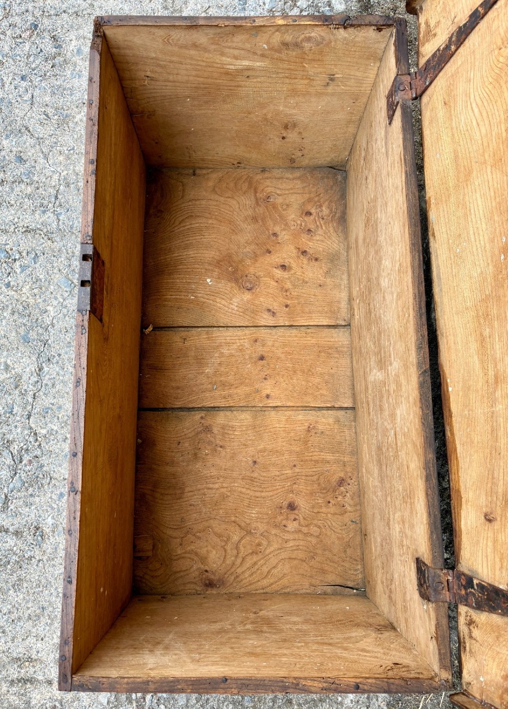 A rectangular antique elm blanket box featuring a hinged lid, visible wood grain, and a central keyhole escutcheon. View V